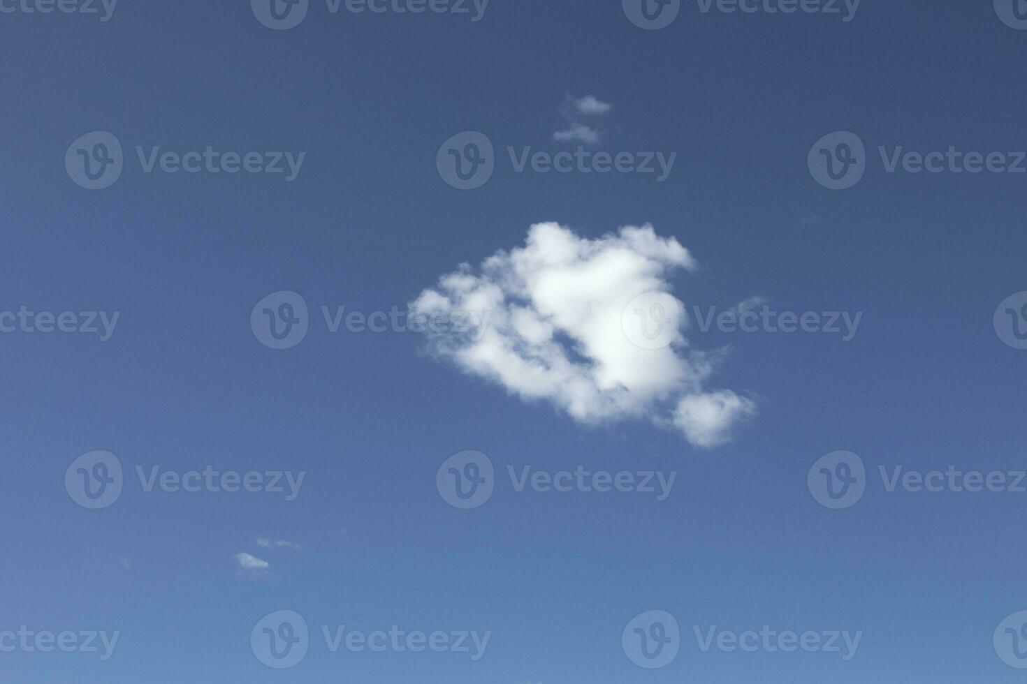 A blue sky with white clouds, coming out some rays of sun, as a background. photo