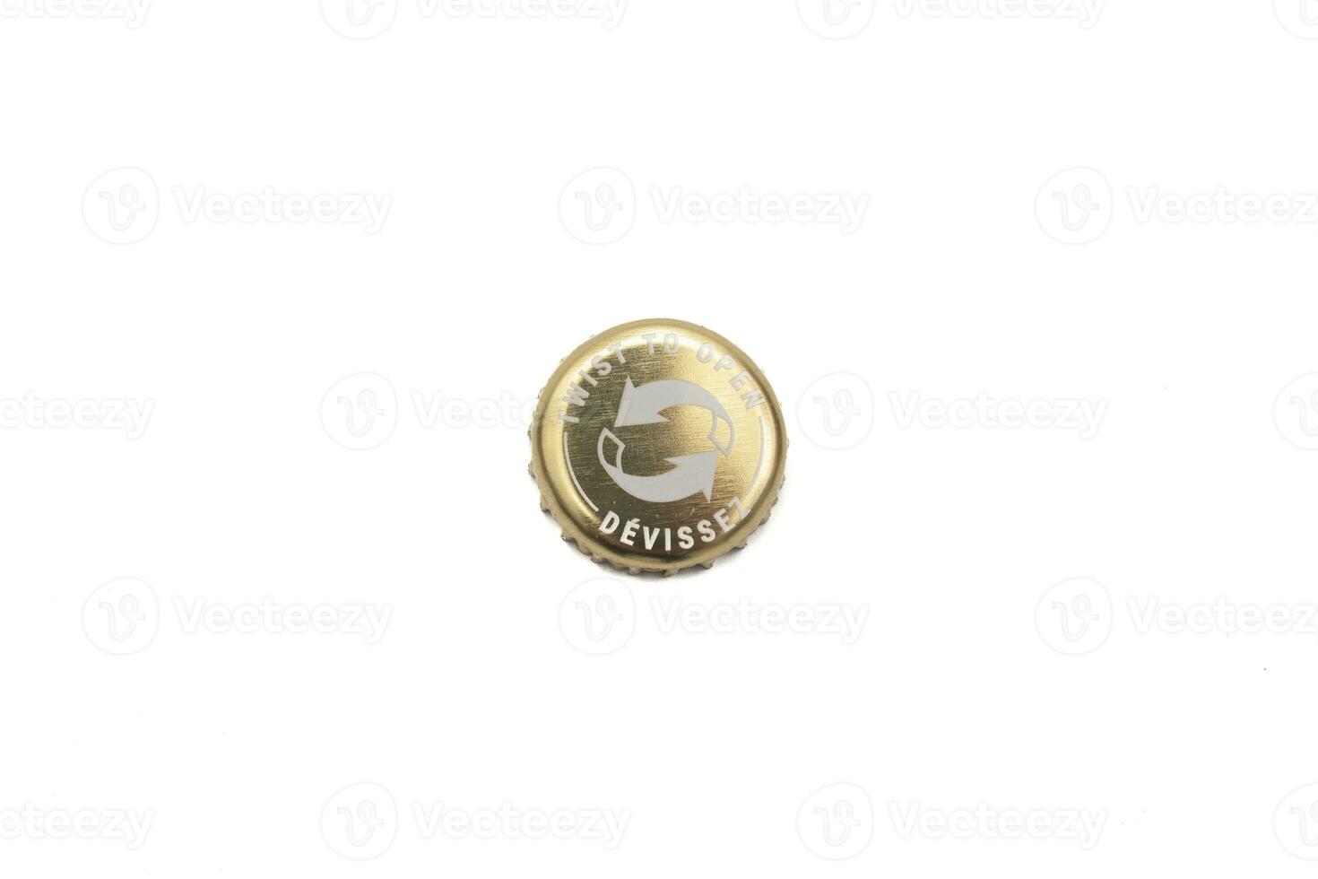 Gold colored beer bottle cap, to open and close. Isolated on white background. photo