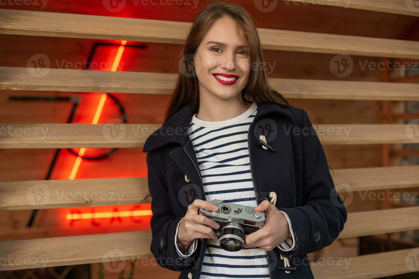 estilo de vida retrato de joven elegante mujer caminando en calle, con cámara, sonriente disfrutar fines de semana foto