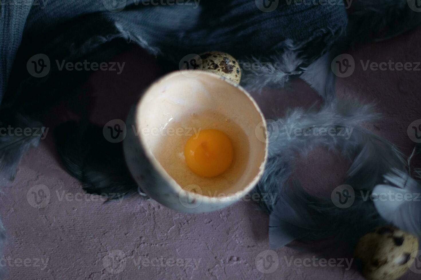 quail eggs in ceramic vases, gray feathers on the table, Easter still life with dietary eggs, diet and antioxidant photo