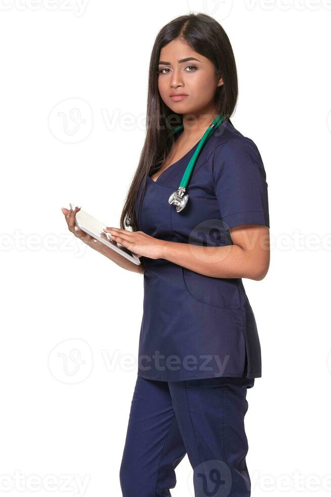 Close up portrait of young indian doctor woman with stethoscope around neck isolated on white background photo