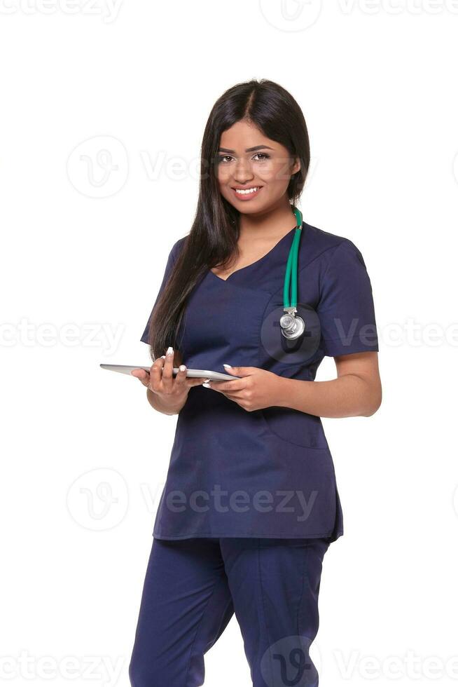 Young pretty doctor with a stethoscope and a medical history in her arms photo