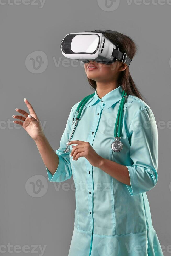 Young attractive doctor in a virtual reality glasses photo