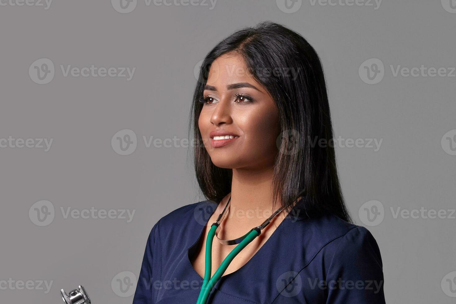 Beautiful young doctor in a medical robe with a stethoscope photo