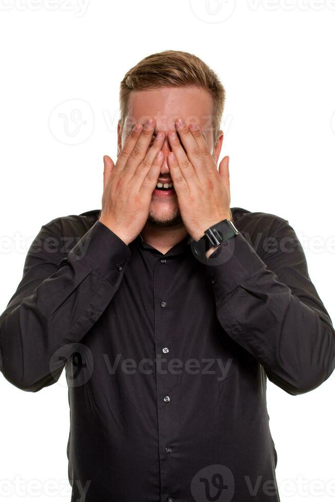 A man shows embarrassment, isolated on a white background photo