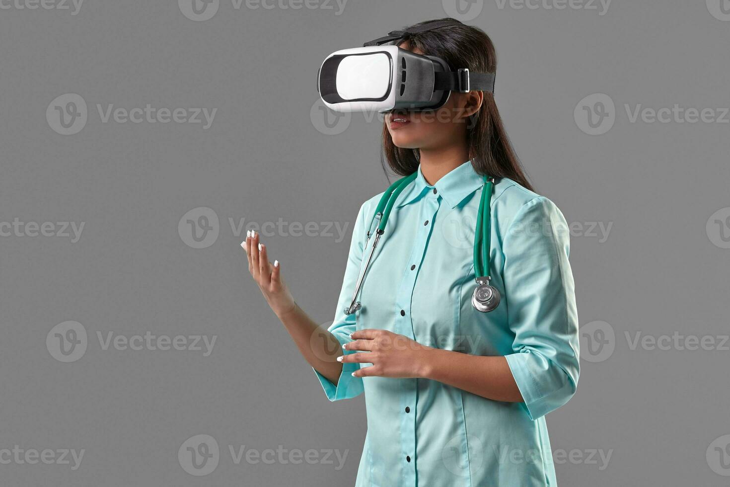 Young attractive doctor in a virtual reality glasses photo