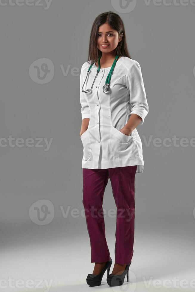 Beautiful young doctor in a medical robe with a stethoscope photo