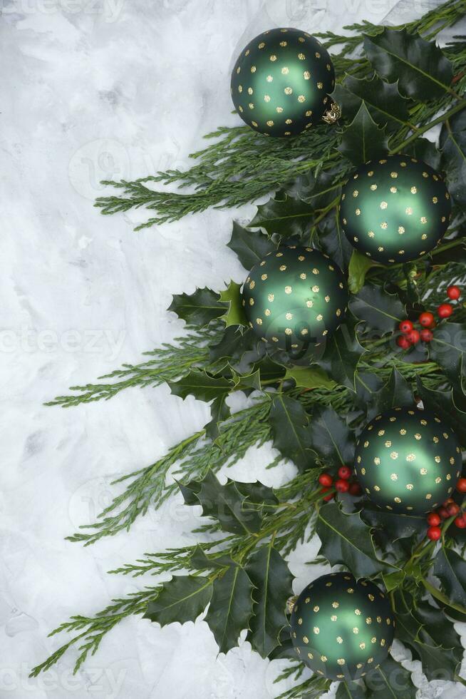 Christmas or new year table decor with fir branches, holly branches with berries photo