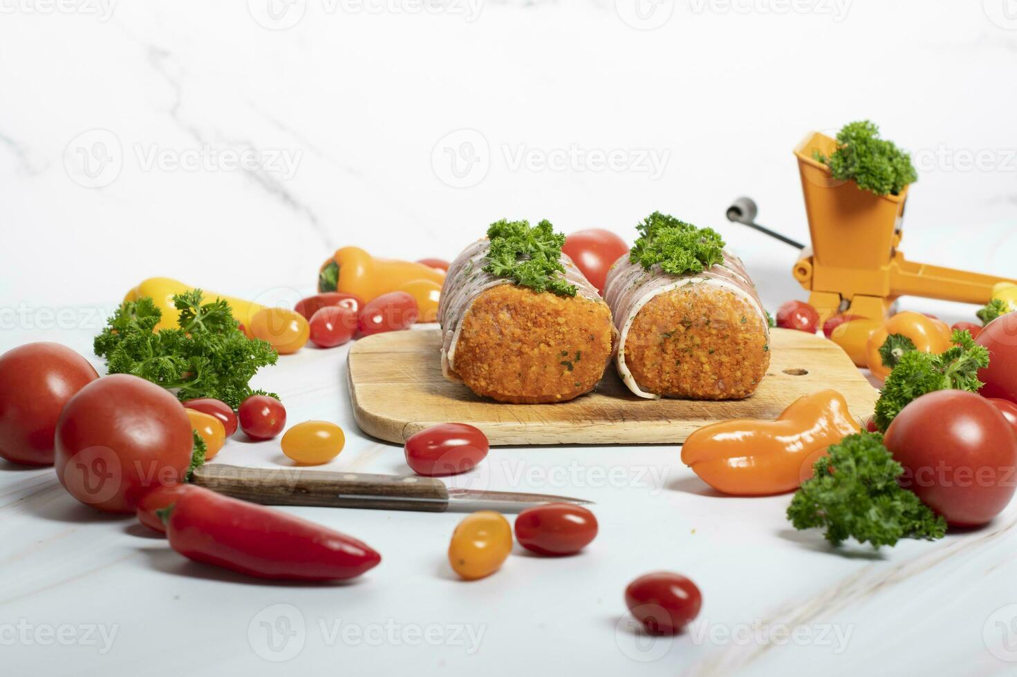 minced meat sausages in bacon with green parsley and fresh vegetables, cherry photo