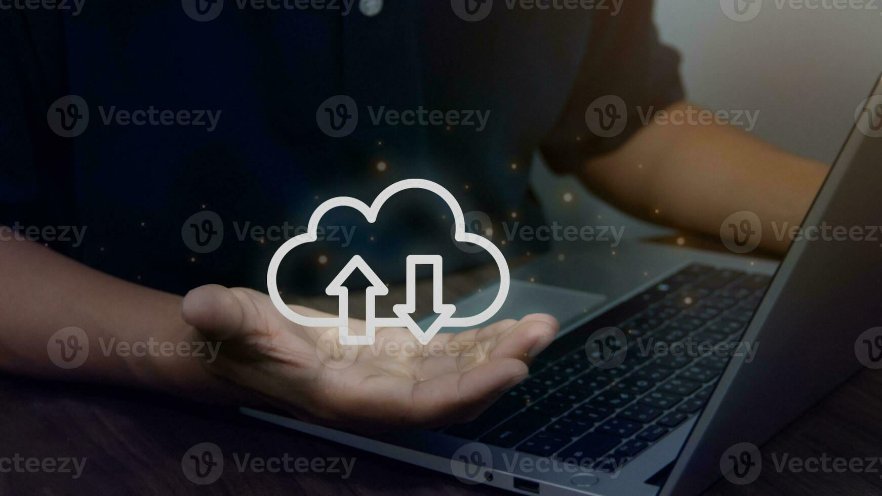 Virtual cloud in hand with laptop on table, cloud computing technology for uploading or downloading data, wireless communication Technology concept business, internet data collection photo