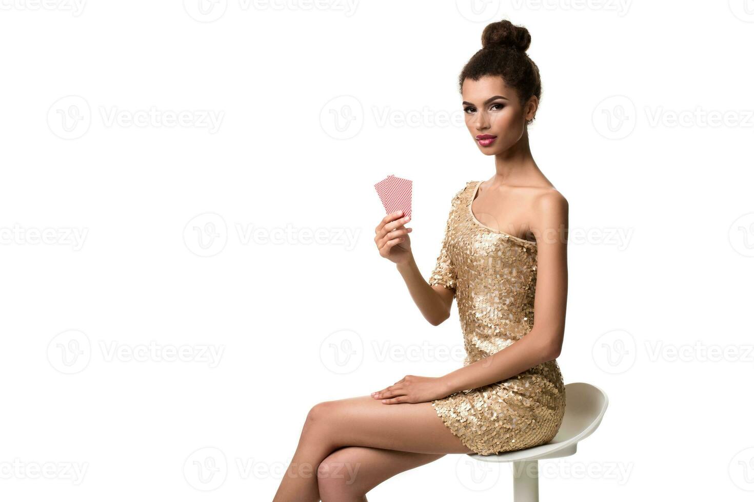 Beautiful young woman holding two cards in her hand isolated on white photo