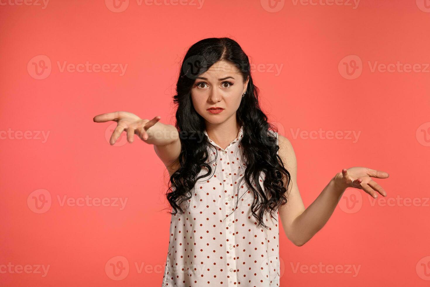 Studio shot of a beautiful girl teenager posing over a pink background. photo