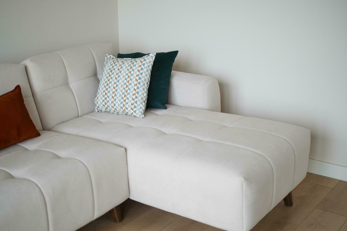 modern sofa with pillows in living room at home photo