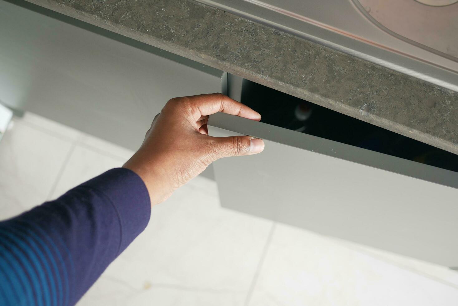 man's hand open drawer wooden in cabinet photo