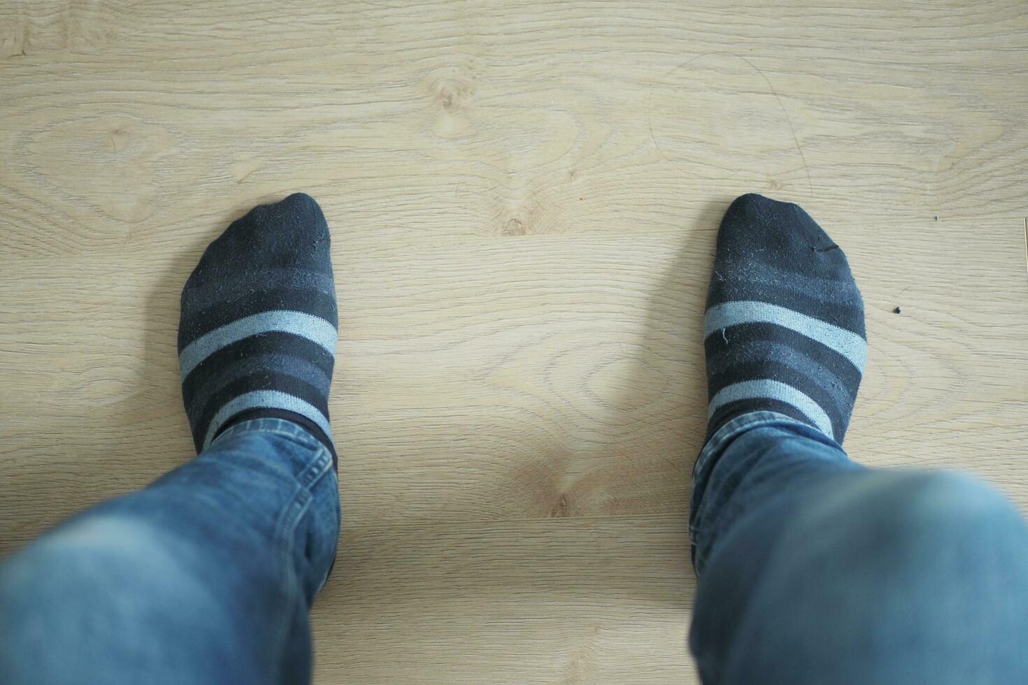 men feet in light socks on the floor. photo