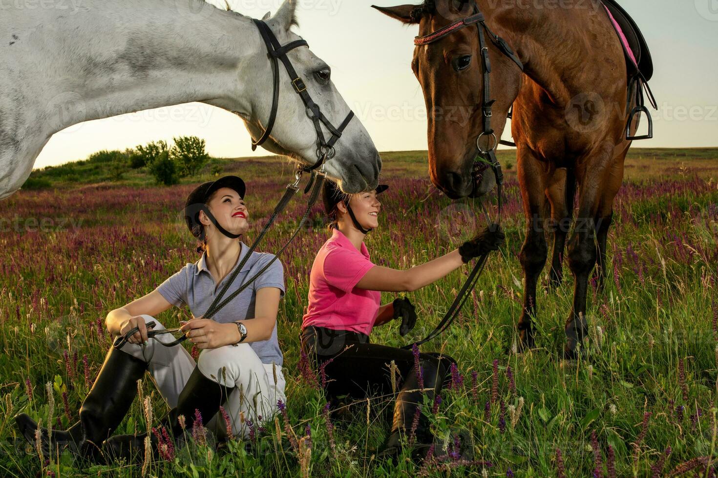 Two woman and two horses outdoor in summer happy sunset together nature photo