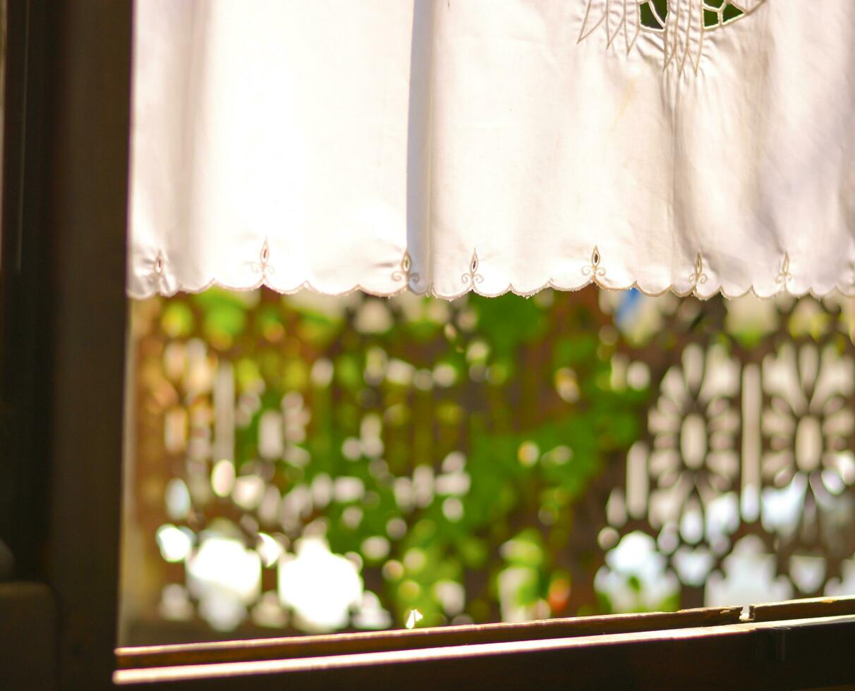 Abstract blur background and texture a picture of a window and white curtains blowing gently in the wind and soft sunlight. photo