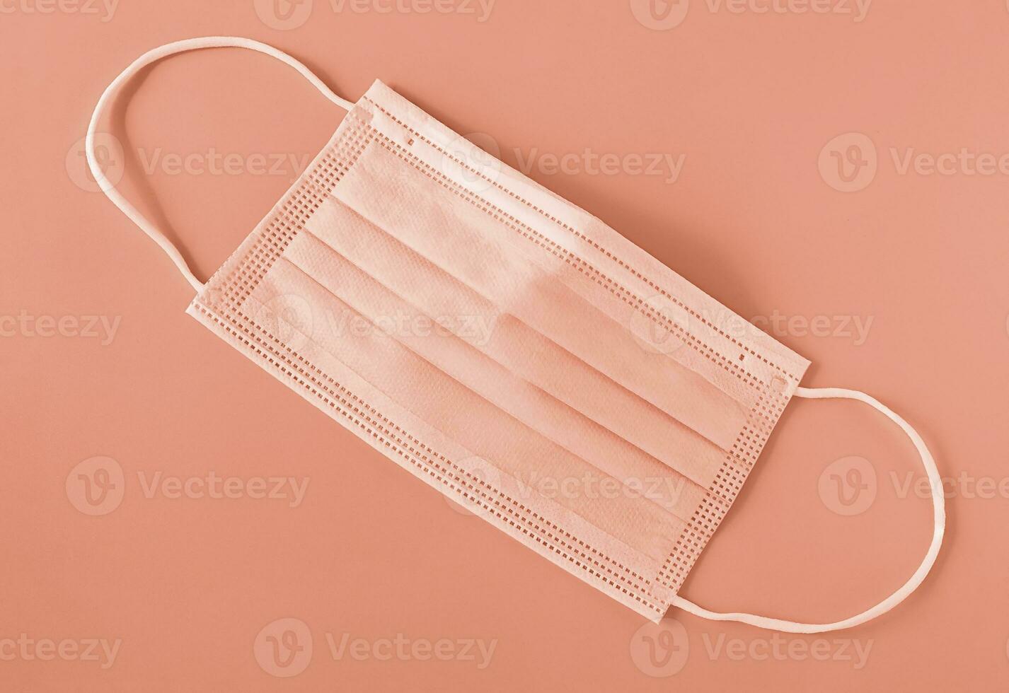 Medical mask, color of year 2024 peach fuzz. photo