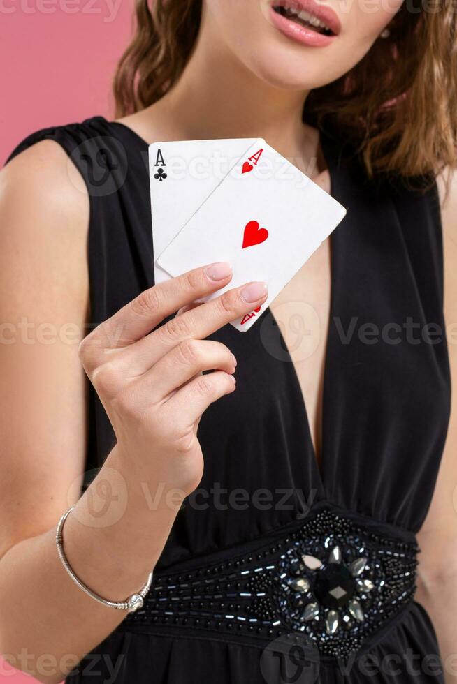 Beautiful caucasian woman with poker cards gambling in casino. Studio shot photo