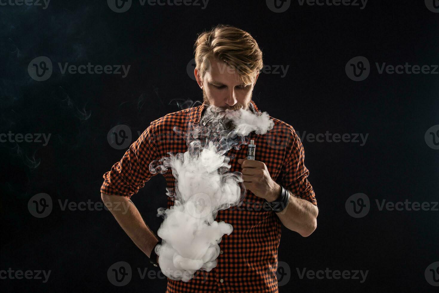 A young man with a beard and a stylish hairstyle in a shirt, smoking a cigarette, a viper, a room, a studio, smoke, enjoyment photo