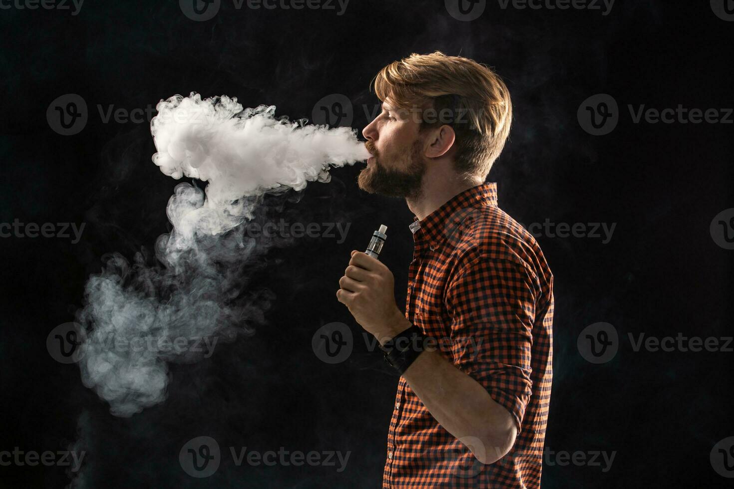 A young man with a beard and a stylish hairstyle in a shirt, smoking a cigarette, a viper, a room, a studio, smoke, enjoyment photo