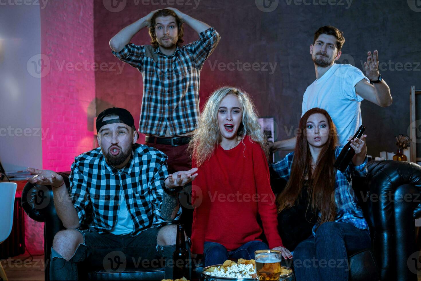 Group of friends watching TV match at home photo