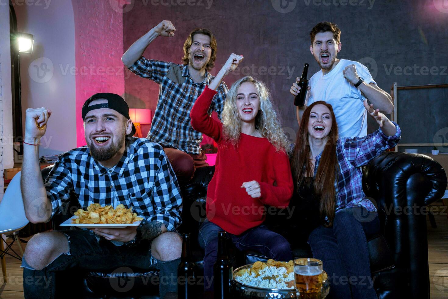 Friends watching a football match and drinking beer. photo