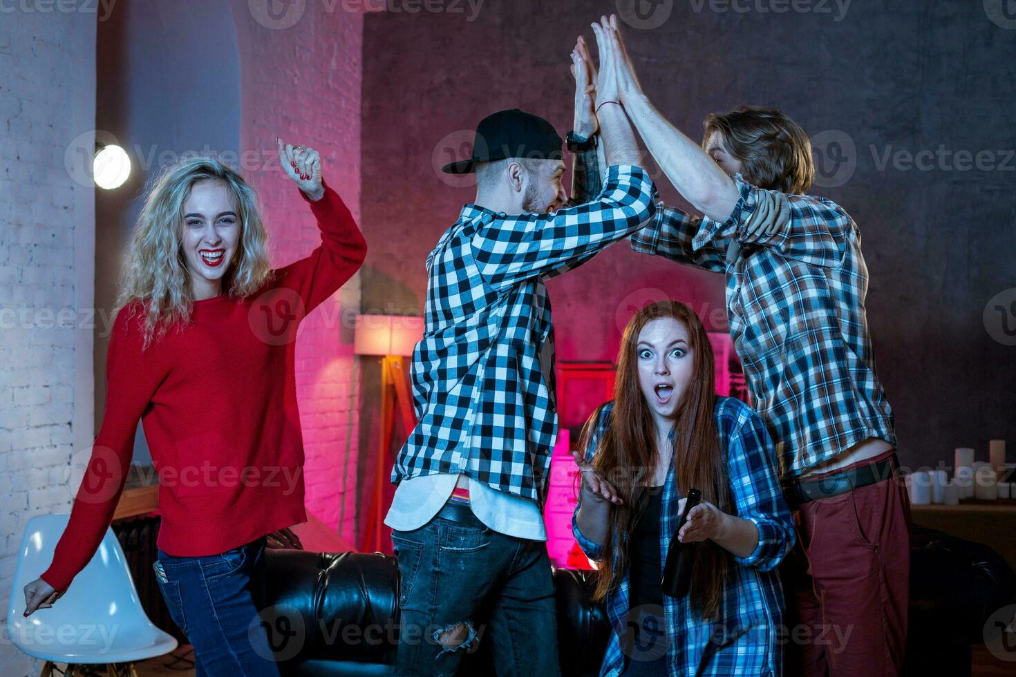 Group of friends watching TV match at home photo