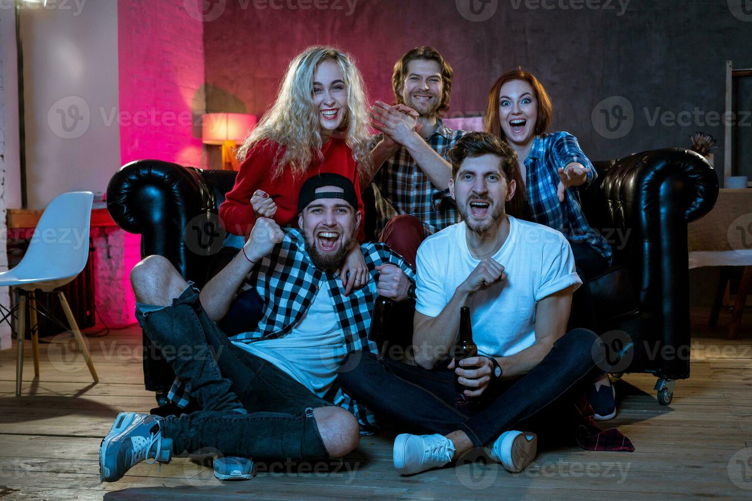 Group of friends watching TV match at home photo