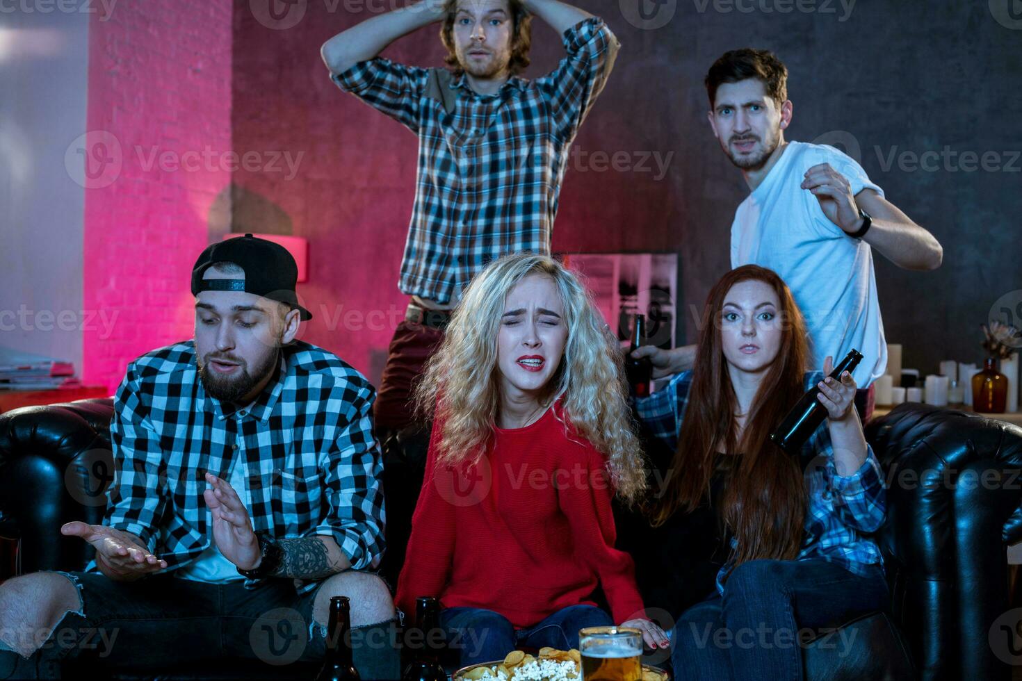 Group of friends watching TV match at home photo