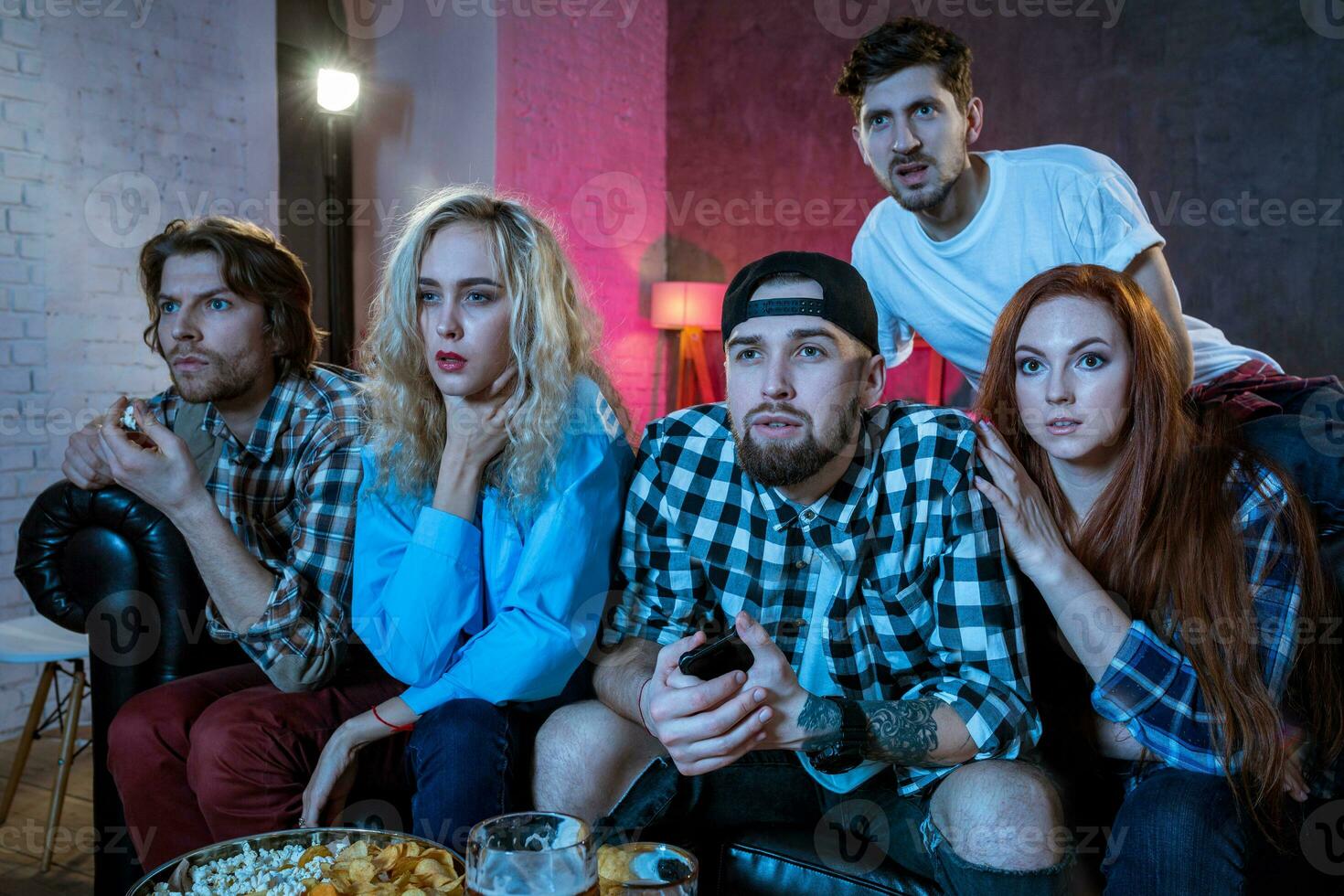 Group of friends watching TV match at home photo