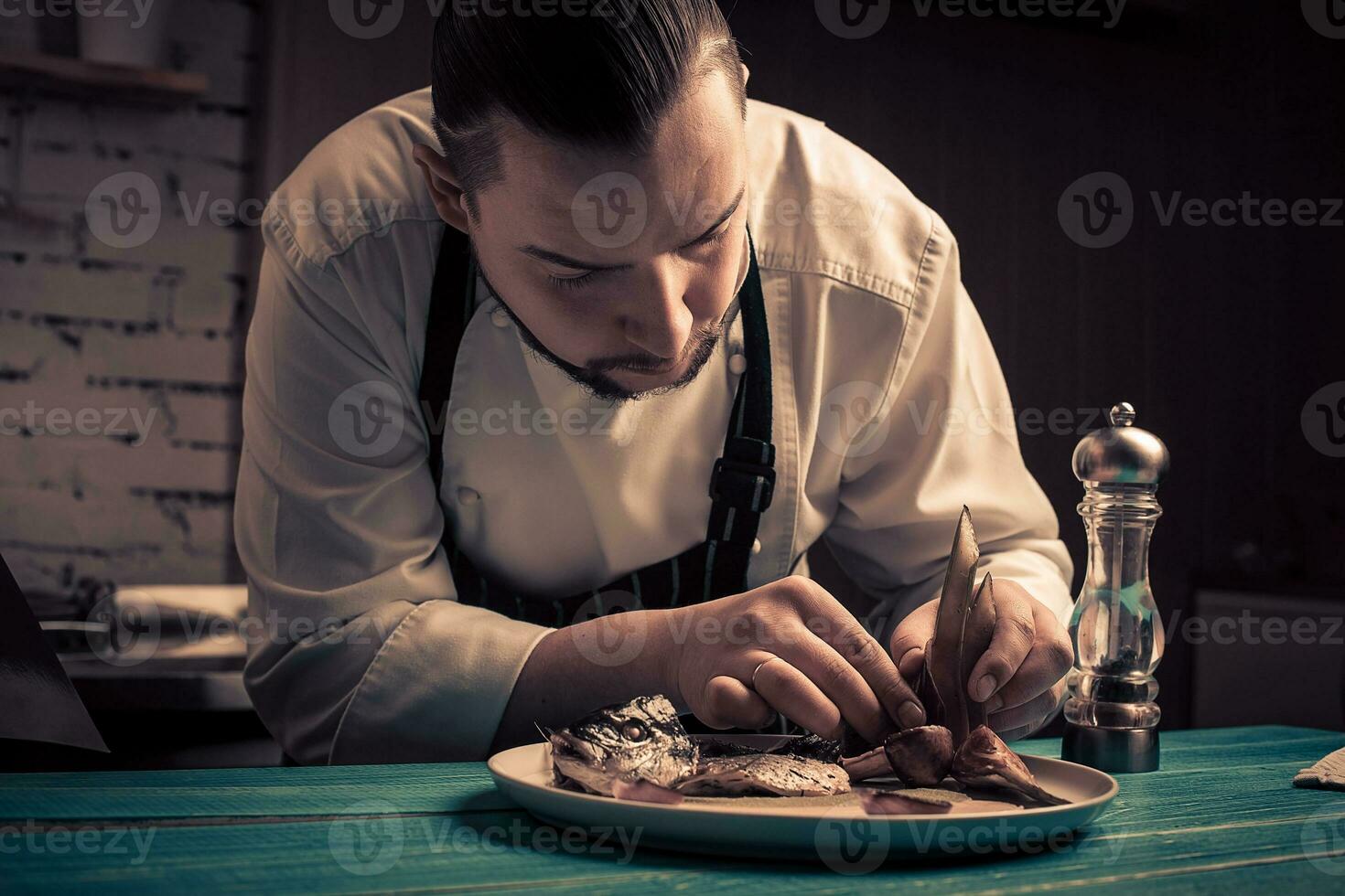 Hand over plate with fish. Cooked fish. Juicy fish on plate. photo