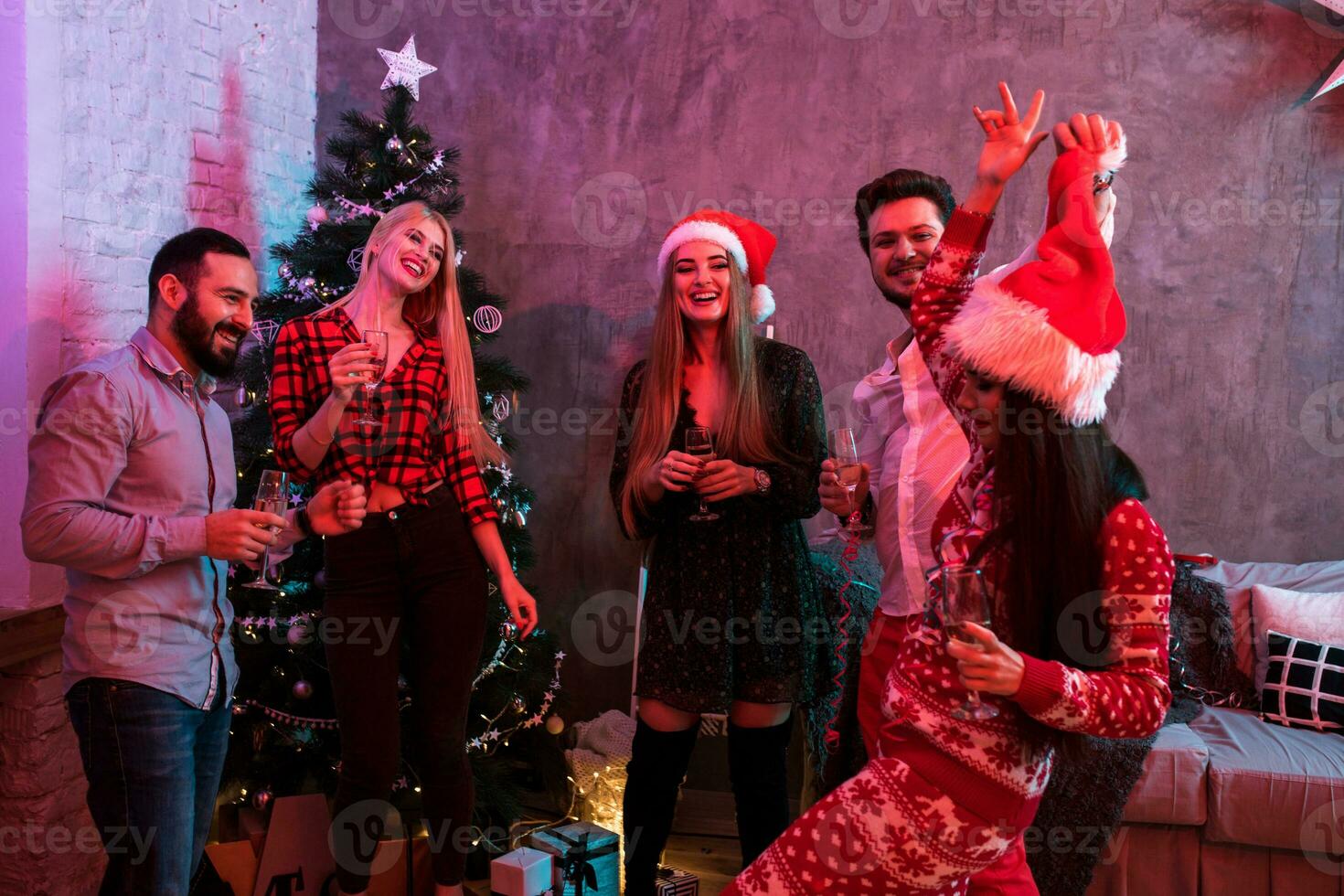 Young people with glasses of champagne at Christmas party photo