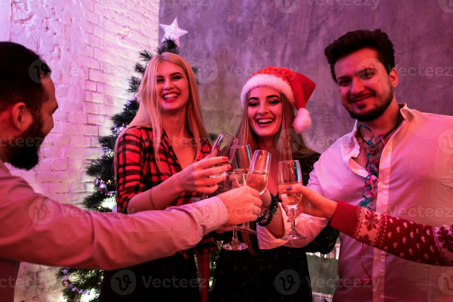 Young people with glasses of champagne at Christmas party photo