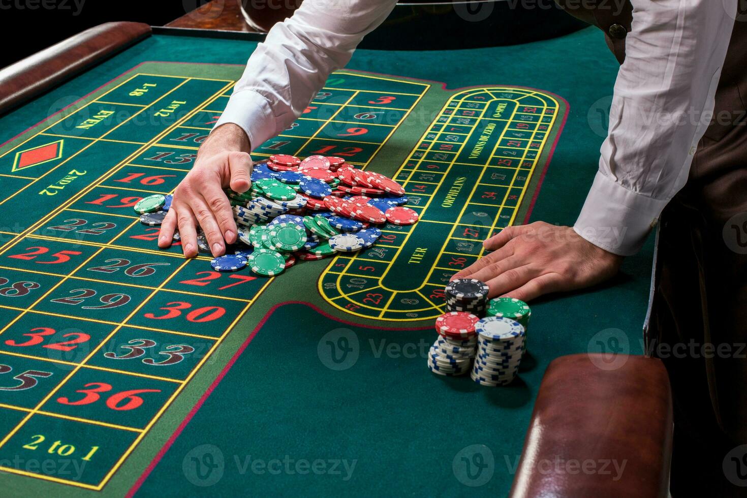 Croupier behind gambling table in a casino. photo