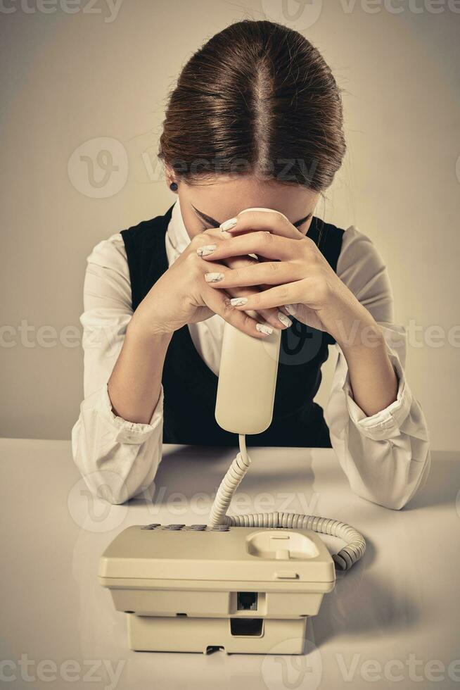 portrait of young secretary answering telephone photo