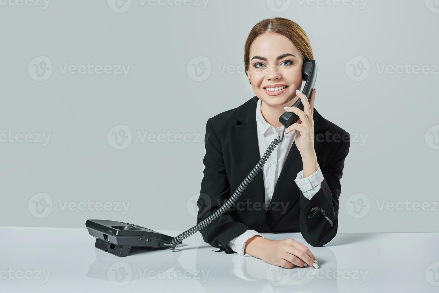 Portrait of young woman sitting at the table and working. photo