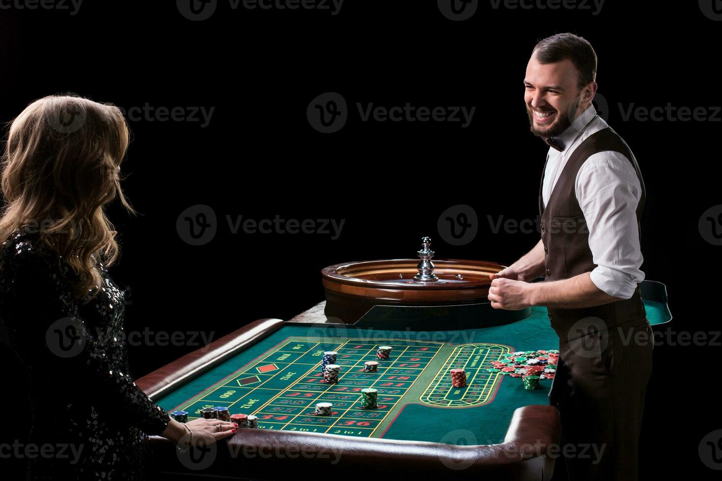 Croupier and woman player at a table in a casino. Picture of a c photo