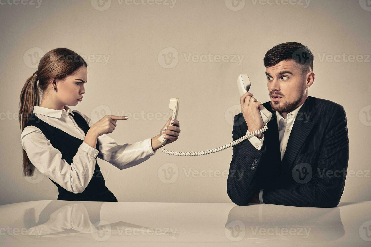 picture of man and woman with telephone at the table photo