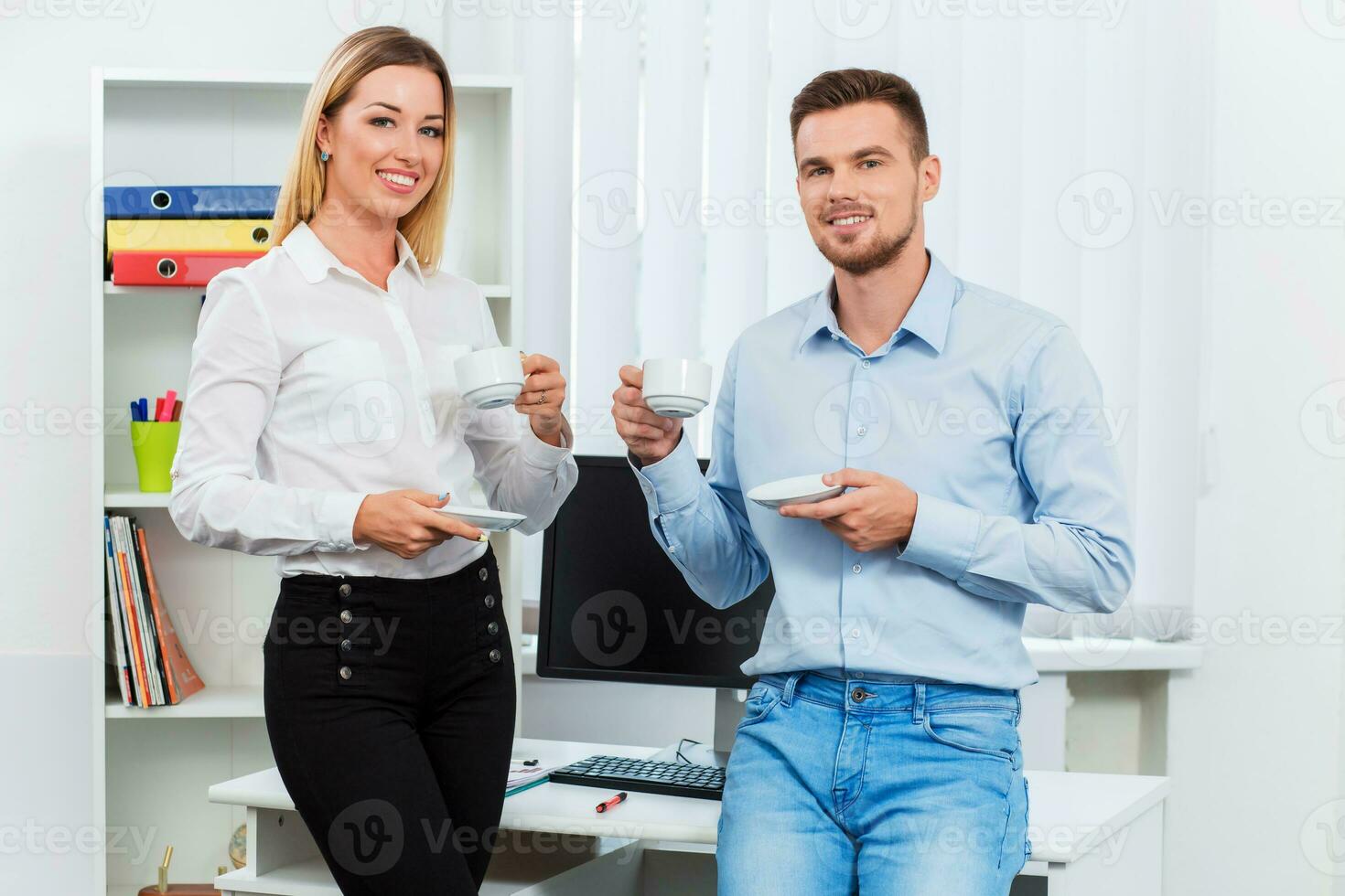 Happy smart business couple discussing photo