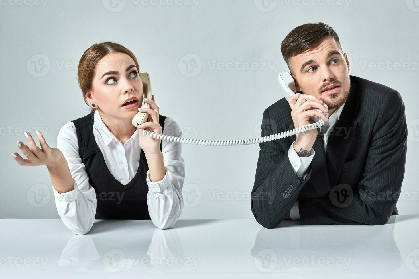 picture of man and woman with telephone at the table photo