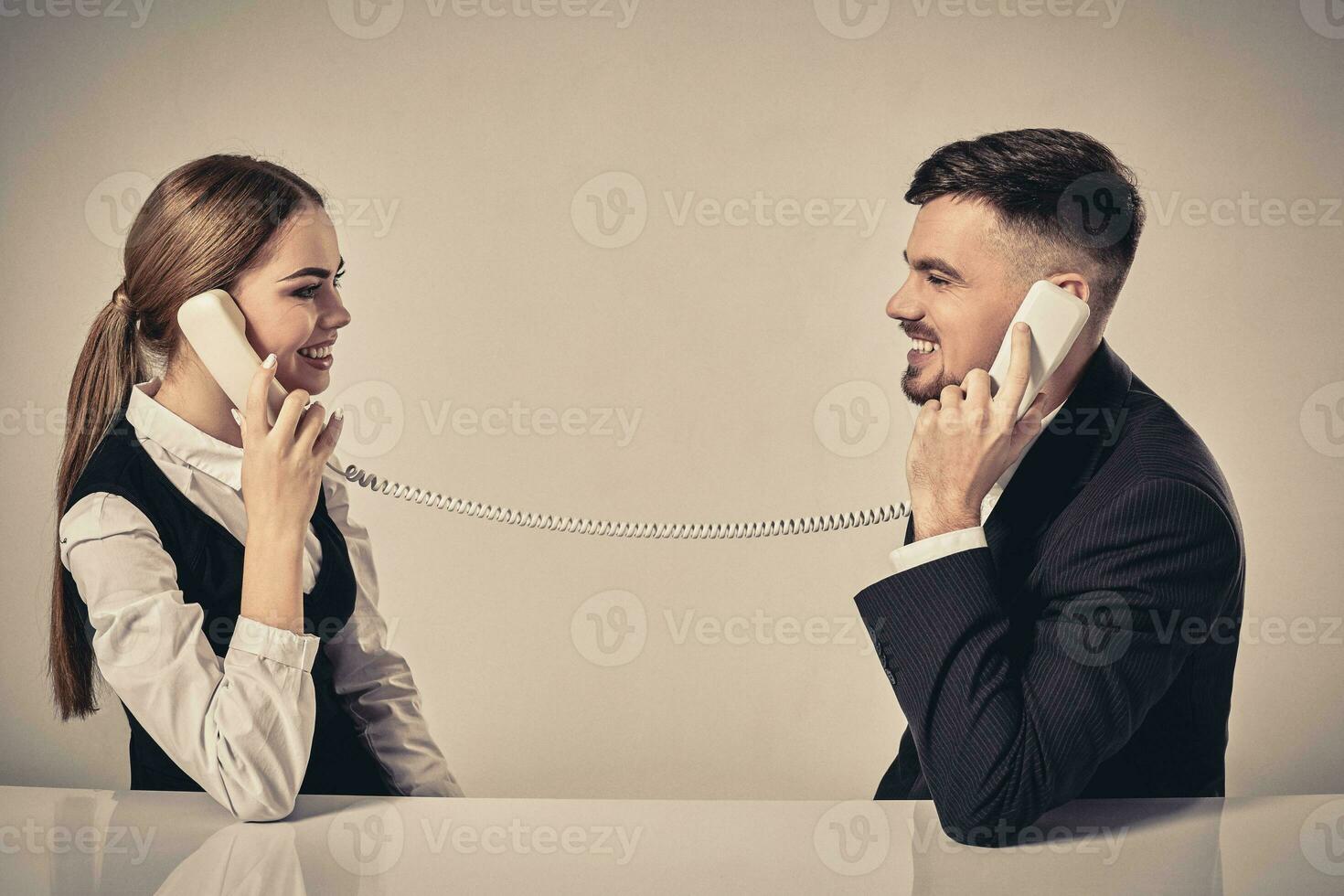 picture of man and woman with telephone at the table photo