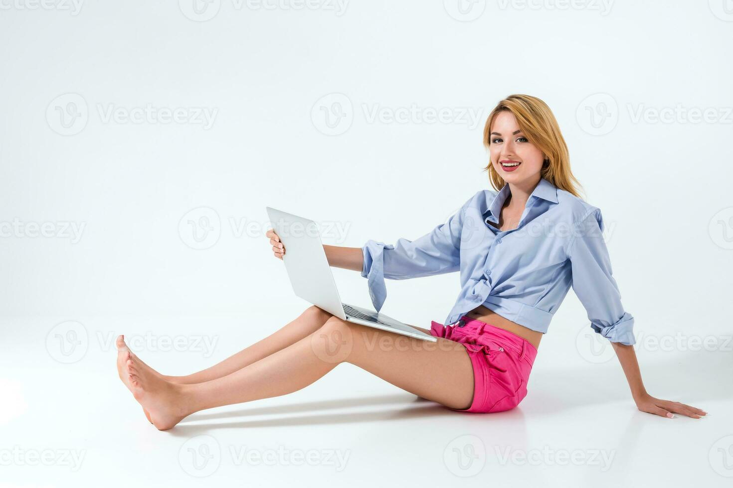 young woman sitting on the floor and using laptop photo