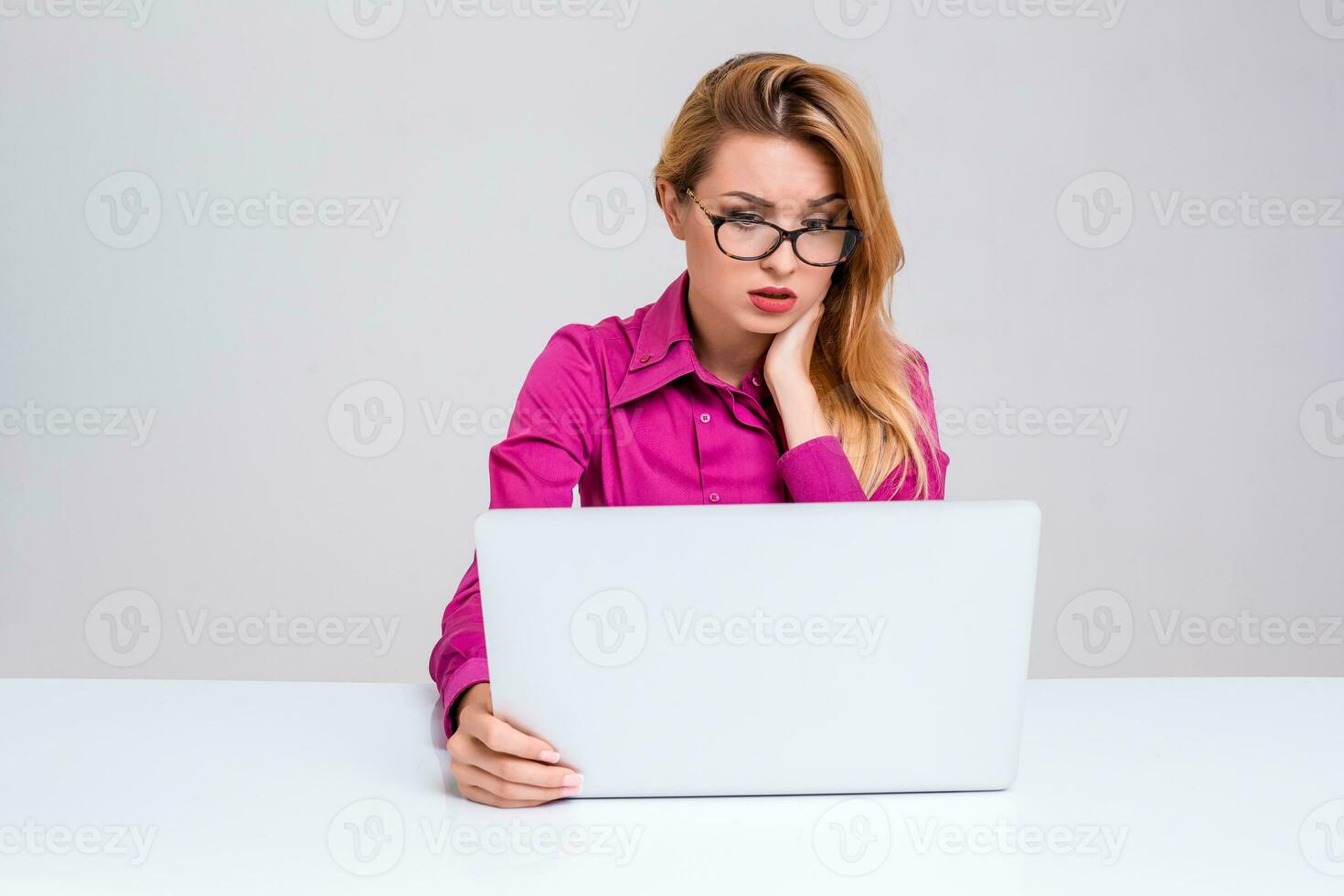 young woman sitting in the table and using laptop photo