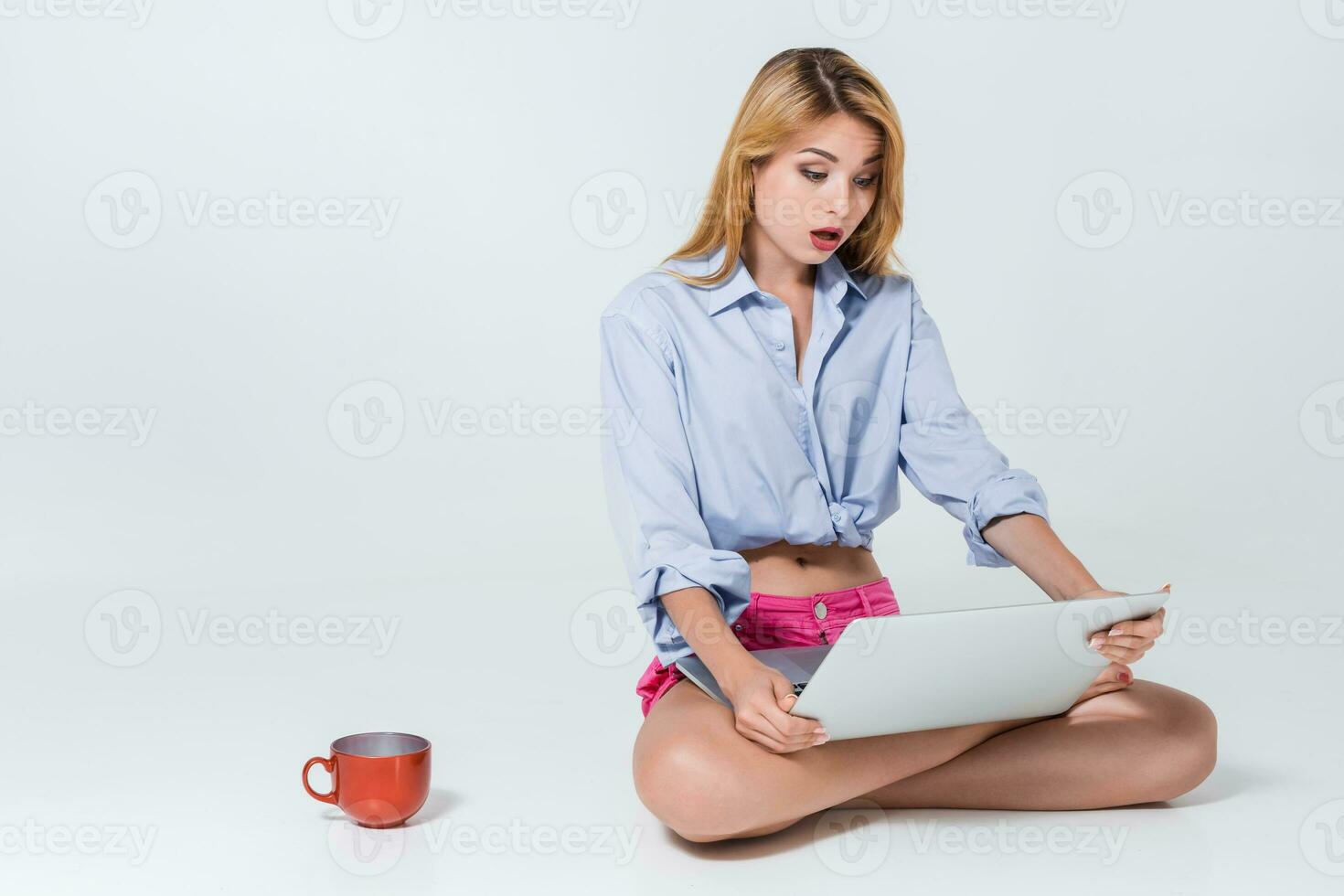 young woman sitting on the floor and using laptop photo