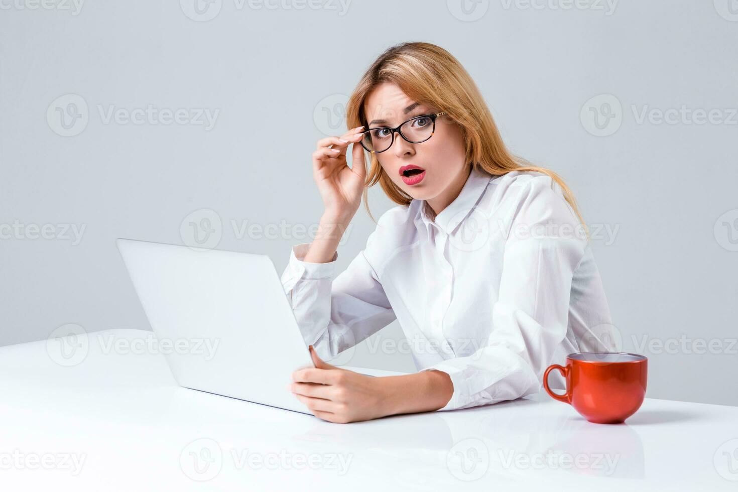 young woman sitting in the table and using laptop photo