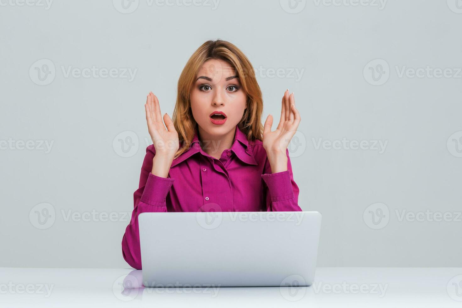 young woman sitting in the table and using laptop photo