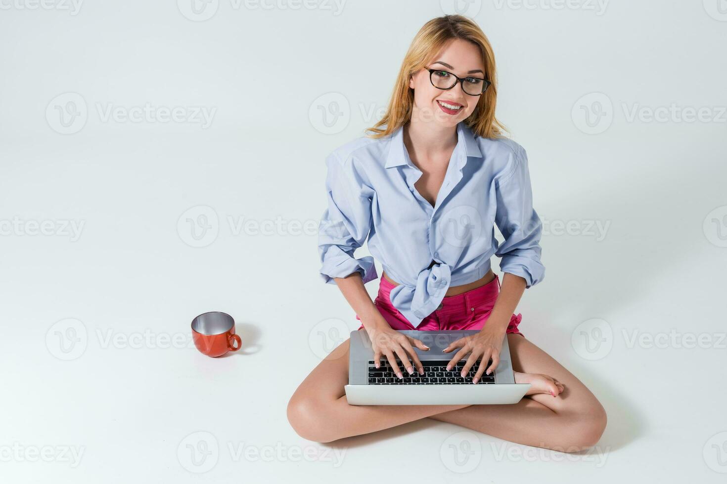 young woman sitting on the floor and using laptop photo