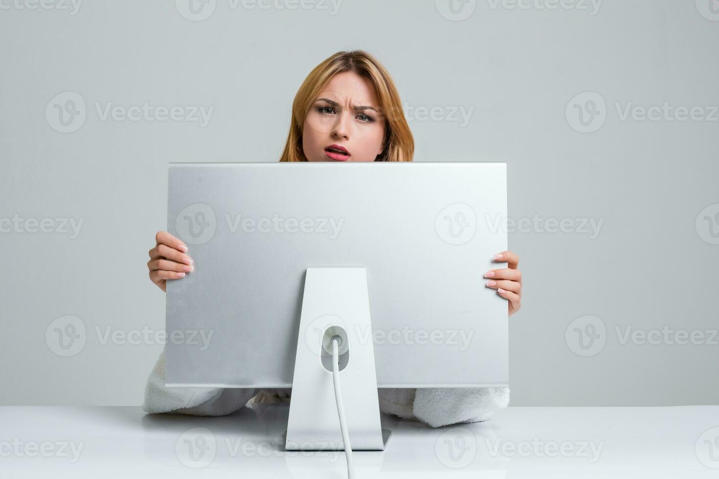 young woman sitting in the table and using computer photo