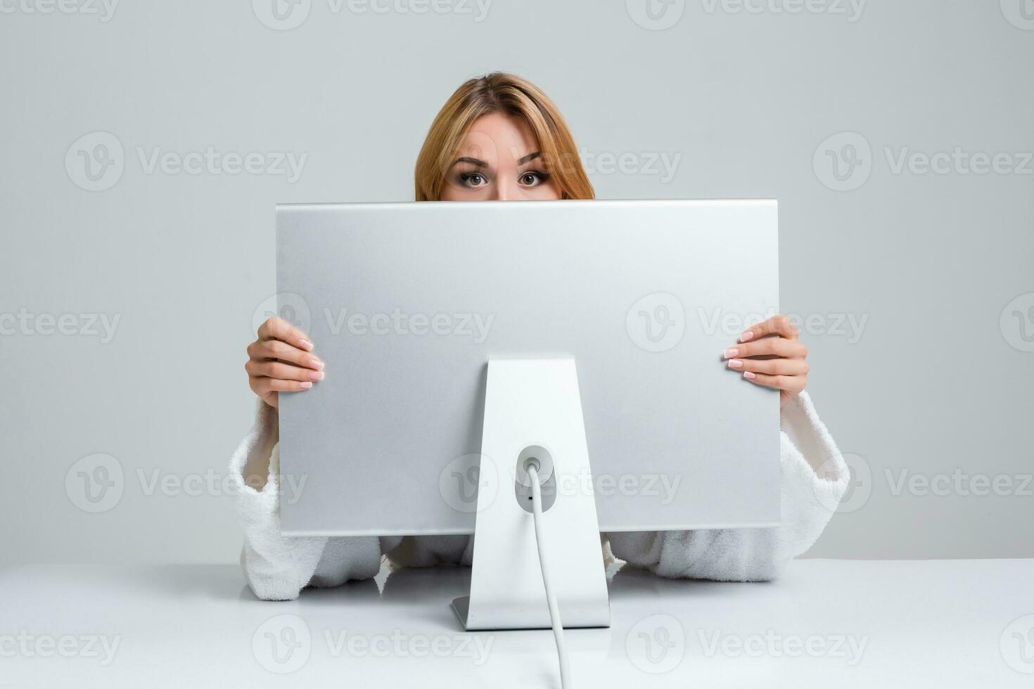 young woman sitting in the table and using computer photo